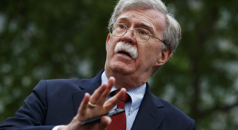 In this May 1, 2019 file photo, National security adviser John Bolton talks to reporters outside the White House in Washington. (AP Photo/Evan Vucci)