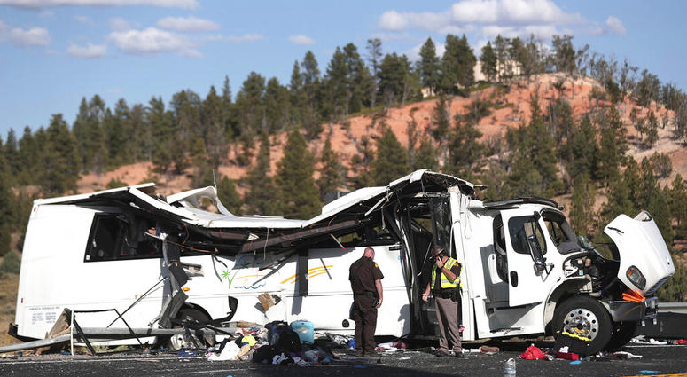Authorities work the scene where at least four people were killed in a tour bus crash near Bryce Canyon National Park, Friday, Sept. 20, 2019, in Utah.