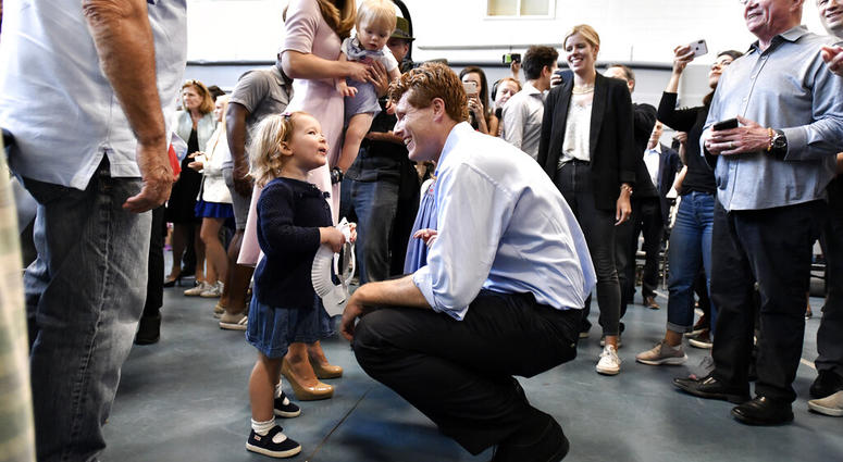 Democratic U.S. Rep. Joseph Kennedy III, D-Mass., speaks to a young supporter as he arrives with his wife Lauren Kennedy, and son James Kennedy, 1, in East Boston to announce his candidacy for the Senate on Saturday, Sept. 21, 2019, in Boston.