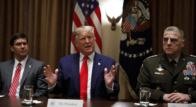 President Donald Trump, joined by from left, Defense Secretary Mark Esper, and Chairman of the Joint Chiefs of Staff Gen. Mark Milley, at the White House in Washington, Monday, Oct. 7, 2019. (AP Photo/Carolyn Kaster)