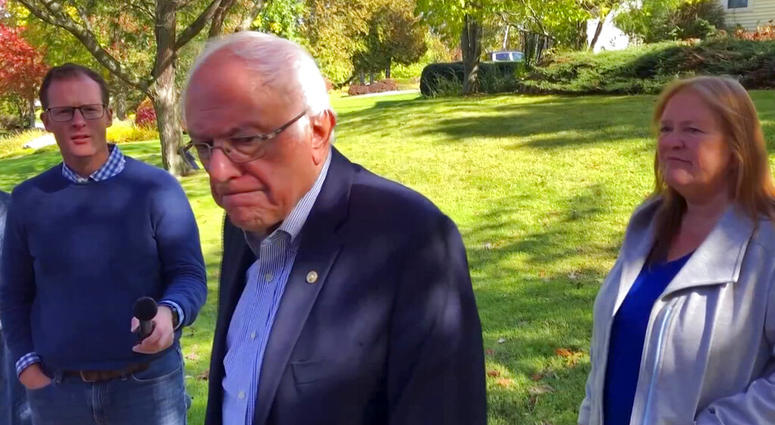Democratic presidential candidate Sen. Bernie Sanders, I-Vt., speaks we reporters outside his home, Tuesday, Oct. 8, 2019, in Burlington, Vt. (AP Photo/Wilson Ring)