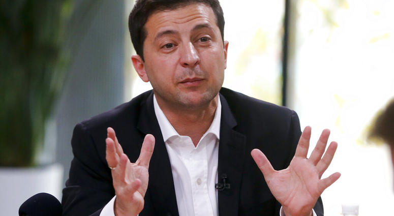 Ukrainian President Volodymyr Zelenskiy speaks during talks with journalists in Kyiv, Ukraine, Thursday, Oct. 10, 2019. (AP Photo/Efrem Lukatsky)