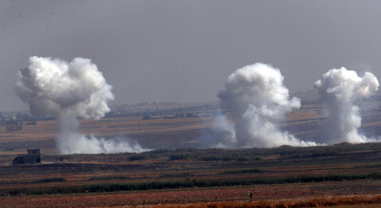 Smoke billows from targets inside Syria during bombardment by Turkish forces Thursday, Oct. 10, 2019. (AP Photo/Lefteris Pitarakis)