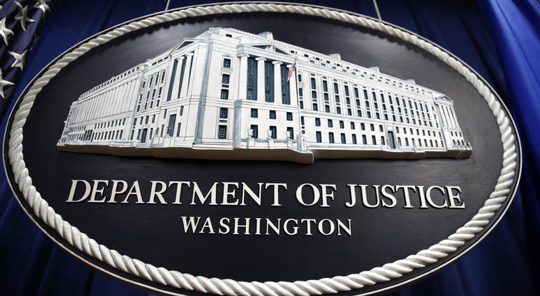In this Thursday, April 18, 2019, file photo, a sign for the Department of Justice hangs in the press briefing room at the Justice Department, in Washington. (AP Photo/Patrick Semansky, File)