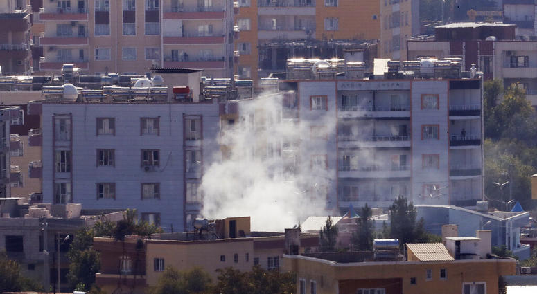 Smoke billows from targets in Ras al-Ayn, Syria, caused by shelling by Turkish forces, Friday, Oct. 18, 2019. (AP Photo/Lefteris Pitarakis)
