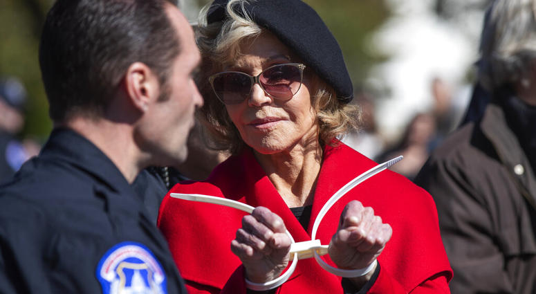 Actress Jane Fonda gestures after being arrested during a rally on Capitol Hill in Washington, Friday, Oct. 18, 2019. (AP Photo/Manuel Balce Ceneta)
