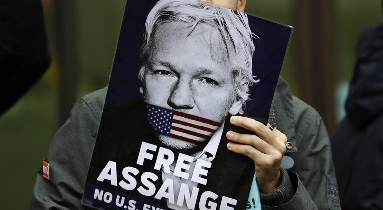 Supporters of Wikileaks founder Julian Assange demonstrate outside Westminster Magistrates' Court in London where Assange is expected to appear as he fights extradition to the United States. (AP Photo/Kirsty Wigglesworth) Supporters of Wikileaks founder Julian Assange demonstrate outside Westminster Magistrates' Court in London where Assange is expected to appear as he fights extradition to the United States. (AP Photo/Kirsty Wigglesworth)