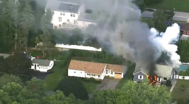 In this image take from video provided by WCVB in Boston, flames rise from a house in Lawrence, Mass, a suburb of Boston, Thursday, Sept. 13, 2018. Emergency crews are responding to what they believe is a series of gas explosions that have damaged homes a