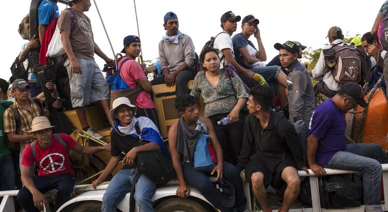 Central American migrants traveling with a caravan to the U.S. crowd onto a tractor as they make their way to Mapastepec, Mexico, Wednesday, Oct. 24, 2018. (AP Photo/Rodrigo Abd)