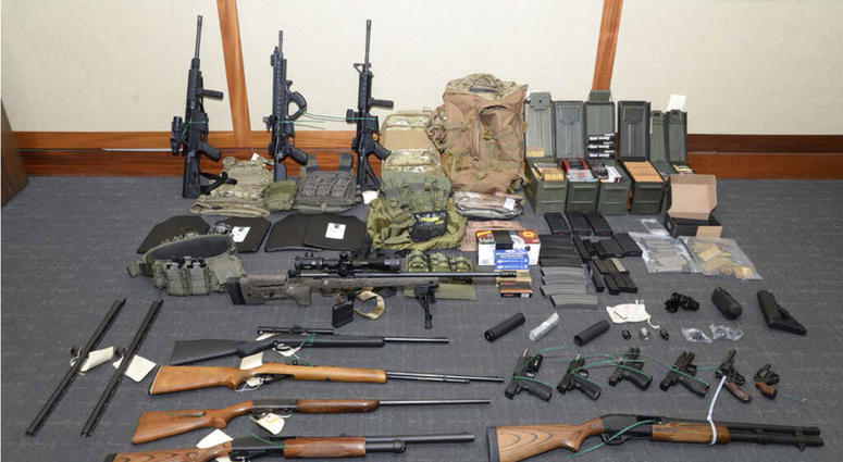This image provided by the U.S. District Court in Maryland shows a photo of firearms and ammunition that was in the motion for detention pending trial in the case against Christopher Paul Hasson. (U.S. District Court via AP)