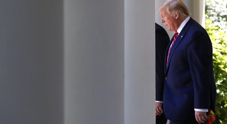 President Donald Trump walks through the Colonnade of the White House, next to Polish President Andrzej Duda, as they arrive for a news conference in the Rose Garden, Wednesday June 12, 2019, in Washington. (AP Photo/Jacquelyn Martin)
