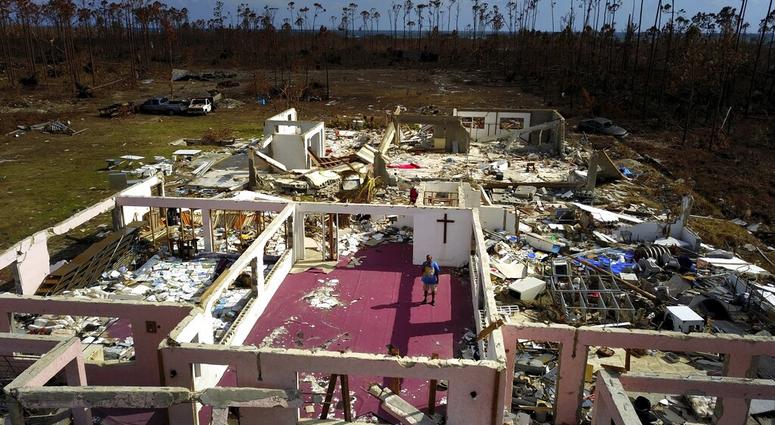 Pastor Jeremiah Saunders poses for a photo among the ruins of his church that was destroyed by Hurricane Dorian, in High Rock, Grand Bahama, Bahamas, Wednesday Sept. 11, 2019. (AP Photo / Ramon Espinosa)