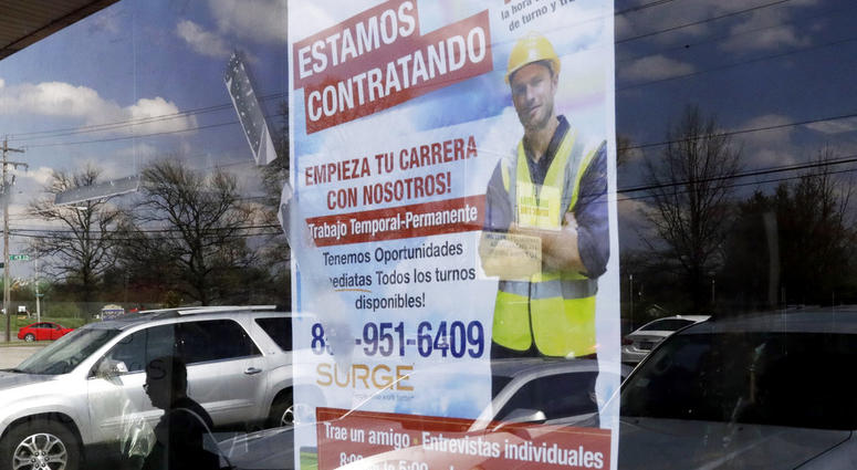 FILE - In this April 27, 2018 file photo, a poster announcing available jobs hangs in the window of the store La Guadalupana in Florence, Ky. One of President Donald Trump’s top priorities _ low unemployment _ is complicating another: curbing immigration.