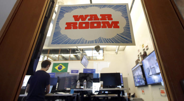 A man works at his desk in the war room, where Facebook monitors election related content on the platform, in Menlo Park, Calif., Wednesday, Oct. 17, 2018. (AP Photo/Jeff Chiu)