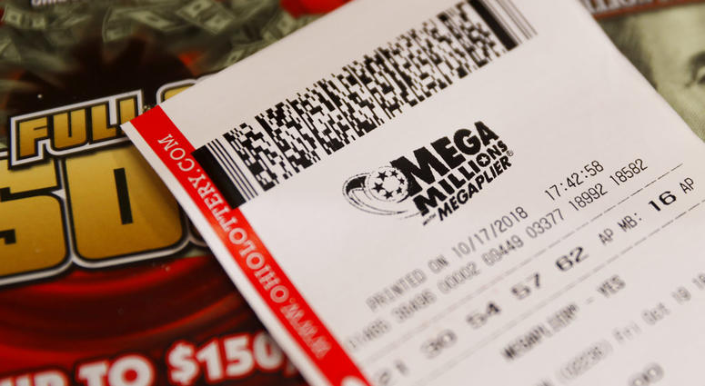 A Mega Millions lottery ticket rests on shop counter. The estimated jackpot for Friday's drawing now more than one billions dollars. (AP Photo/John Minchillo)