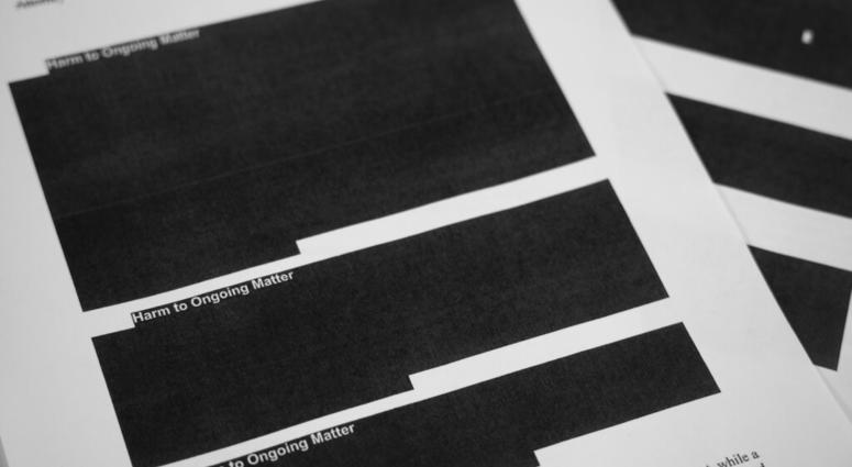 Special counsel Robert Mueller's report, with redactions, as released on Thursday, April 18, 2019, is photographed in Washington. (AP Photo/Jon Elswick)