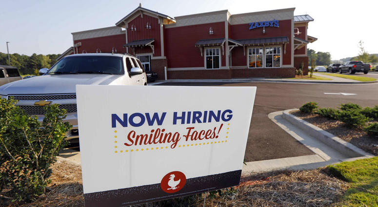 This July 25, 2018, photo shows a help wanted sign at a new Zaxby's restaurant in Madison, Miss. On Friday, Sept. 7, the Labor Department reports on job openings and labor turnover for August. (AP Photo/Rogelio V. Solis)