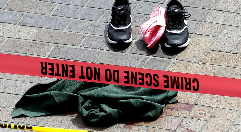 Clothing is strewn on the sidewalk at a scene where pedestrians were hit by a motorist in Portland, Ore., Friday, May 25, 2018. Police say three women have been injured in a hit-and-run crash near Portland State University.
