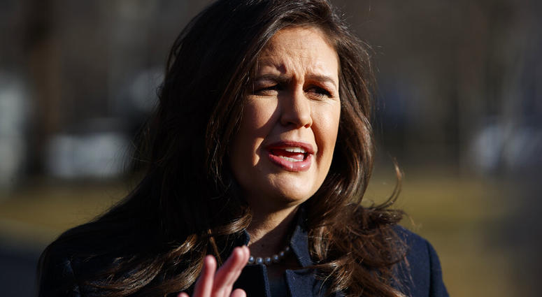 White House press secretary Sarah Sanders talks with reporters outside the White House, Wednesday, Feb. 13, 2019, in Washington. (AP Photo/ Evan Vucci)