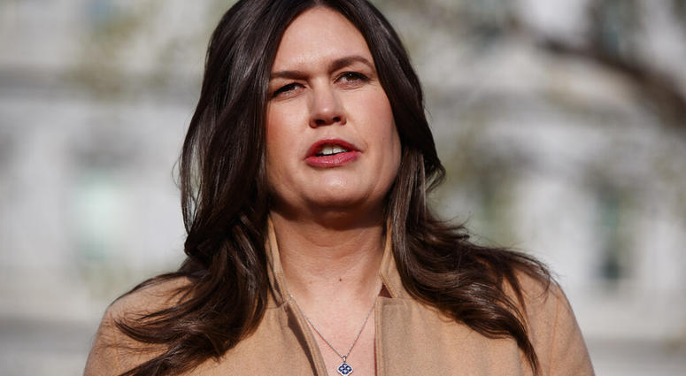 FILE - In this April 4, 2019, file photo, White House press secretary Sarah Sanders talks with reporters outside the White House in Washington. (AP Photo/Evan Vucci, File)