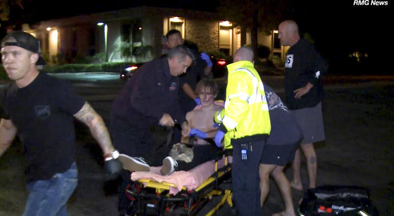 A victim is treated near the scene of a shooting, Wednesday evening, Nov. 7, 2018, in Thousand Oaks, Calif. (RMG News via AP)