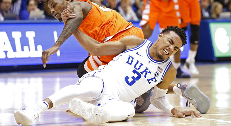 Duke's Tre Jones (3) tangles with Syracuse's Frank Howard during the first half of an NCAA college basketball game in Durham, N.C., Monday, Jan. 14, 2019. Jones was injured on the play and left the court. No. 1-for-now Duke will have to figure out how to