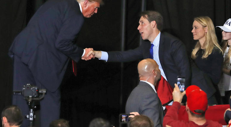 President Donald Trump shakes hands with Republican Senate candidate Josh Hawley at the end of a campaign rally Nov. 5, 2018. (AP Photo/Jeff Roberson)