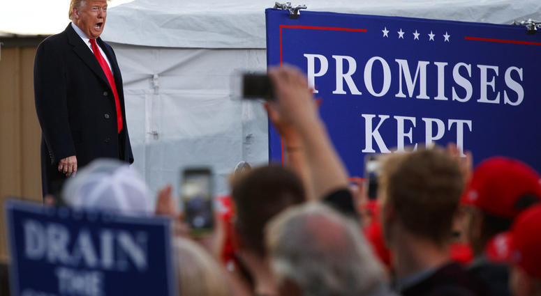 President Donald Trump calls out as he arrives at a campaign rally at Minuteman Aviation Hangar, Thursday, Oct. 18, 2018, in Missoula, Mont. (AP Photo/Carolyn Kaster)
