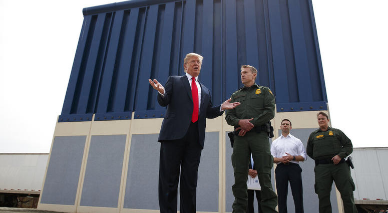 FILE - In this March 13, 2018, file photo, President Donald Trump talks with reporters as he reviews border wall prototypes in San Diego. (AP Photo/Evan Vucci, File)