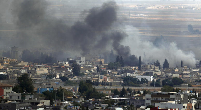 In this photo taken from the Turkish side of the border between Turkey and Syria, in Ceylanpinar, Sanliurfa province, southeastern Turkey, smoke billows from targets in Ras al-Ayn, Syria, during bombardment by Turkish forces. (AP Photo/Lefteris Pitarakis)
