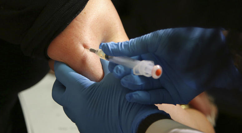 FILE - In this March 27, 2019, file photo, a woman receives a measles, mumps and rubella vaccine. Measles cases in the U.S. this year have climbed to the highest level in 25 years. (AP Photo/Seth Wenig, File)