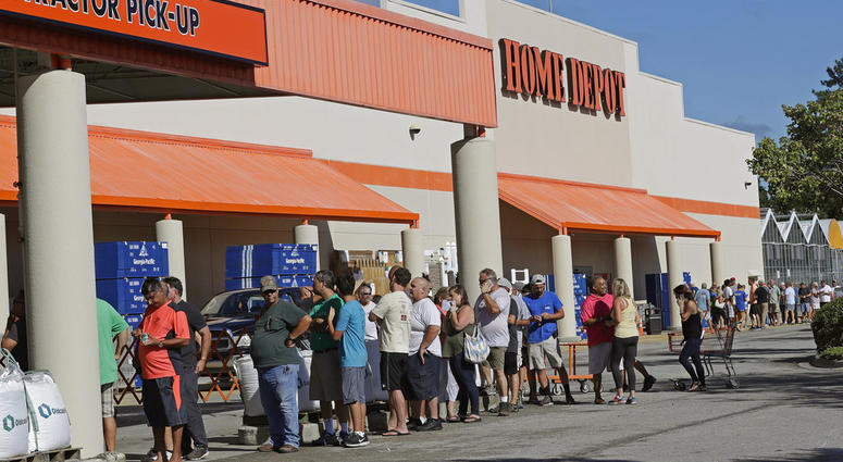People line up outside a Home Depot for a new supply of generators and plywood in advance of Hurricane Florence in Wilmington, N.C., Wednesday, Sept. 12, 2018. Florence exploded into a potentially catastrophic hurricane Monday as it closed in on North and
