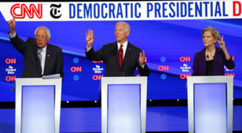 Democratic presidential candidate Sen. Bernie Sanders, I-Vt., left, former Vice President Joe Biden, center, and Sen. Elizabeth Warren, D-Mass., raise their hands to speak during last night's debate. (AP Photo/John Minchillo)
