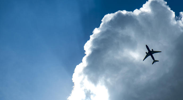 Passenger airplane in the clouds and sunray.(Dreamstime) Passenger airplane in the clouds and sunray.(Dreamstime)