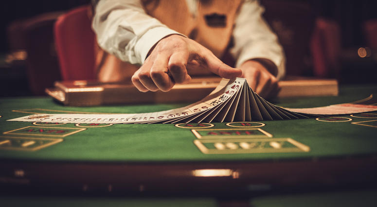 Croupier behind gambling table in a casino. (Dreamstime) Croupier behind gambling table in a casino. (Dreamstime)