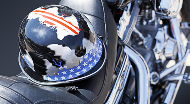 Motorbike motor detail of a Harley Davidson with a helmet on the saddle