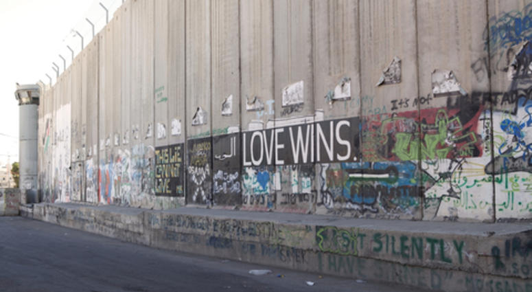 Love wins mural on the Israeli West Bank barrier near Bethlehem, Israel. The Israeli West Bank barrier is a security and separation barrier along and within the West Bank.