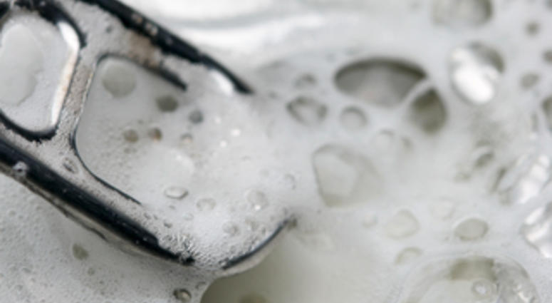Opened beer can with froth close-up