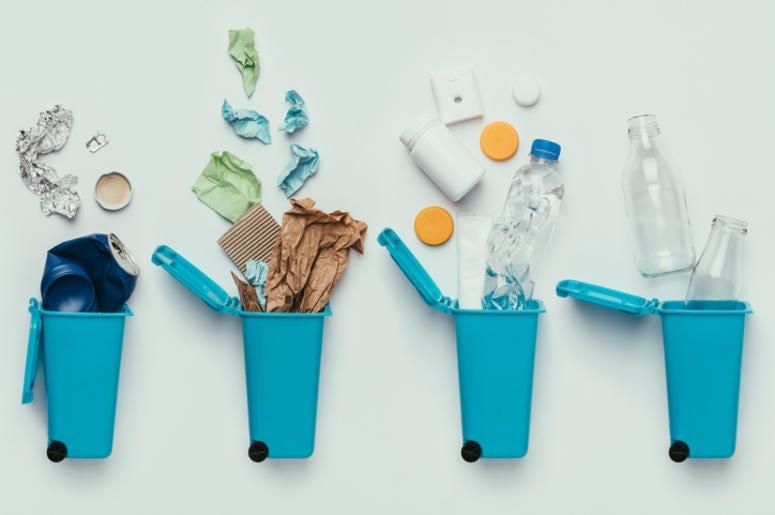 top view of trash bins and assorted garbage isolated on grey, recycle concept top view of trash bins and assorted garbage isolated on grey, recycle concept