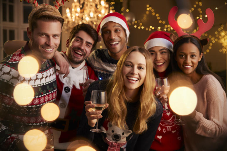 Portrait Of Friends In Festive Jumpers At Christmas Party Portrait Of Friends In Festive Jumpers At Christmas Party