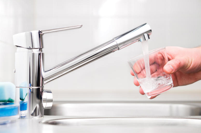 Filling glass with tap water. Modern faucet and sink. Filling glass with tap water. Modern faucet and sink.