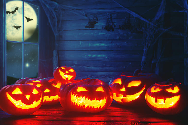 Spooky halloween background. scary pumpkin with burning eyes Spooky halloween background. scary pumpkin with burning eyes