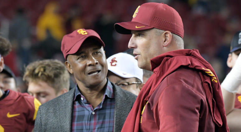 Southern California Trojans athletic director Lynn Swann (left) talks with head coach Clay Helton after the Pac-12 Conference championship game against the Stanford Cardinal at Levi's Stadium Southern California Trojans athletic director Lynn Swann (left) talks with head coach Clay Helton after the Pac-12 Conference championship game against the Stanford Cardinal at Levi's Stadium