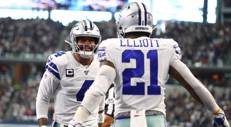 Dallas Cowboys running back Ezekiel Elliott (21) celebrates his third quarter touchdown with quarterback Dak Prescott (4) against the New York Giants at AT&T Stadium Dallas Cowboys running back Ezekiel Elliott (21) celebrates his third quarter touchdown with quarterback Dak Prescott (4) against the New York Giants at AT&T Stadium