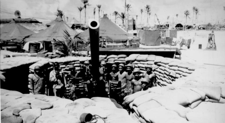51st Defense Battalion, one of two such Negro units in the Corps. Surrounded by a veteran crew of Marines who have spent 15 months in the Southwest and Central Pacific, this gun, named the 'Lena Horne' by its crew, points majestically skyward.