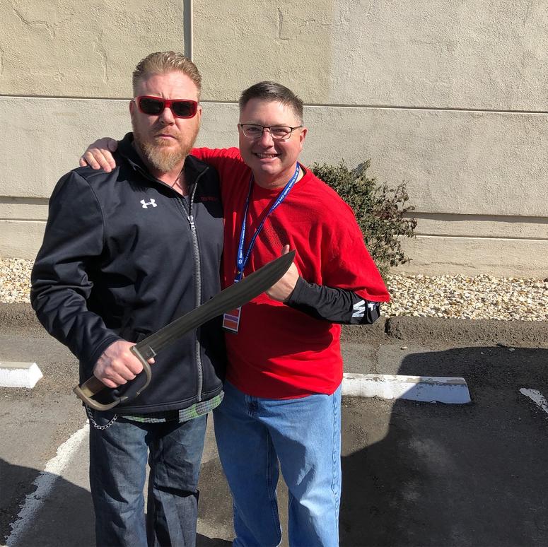 Spartan Pledge author Boone Cutler and David Sousa take the pledge with the spartan sword, forged from steel from the World Trade Centers on 9/11.