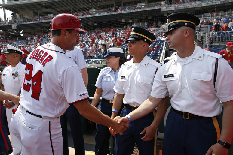 Nationals First Base Coach Tim Bogar greets military members honored before the game Nationals First Base Coach Tim Bogar greets military members honored before the game