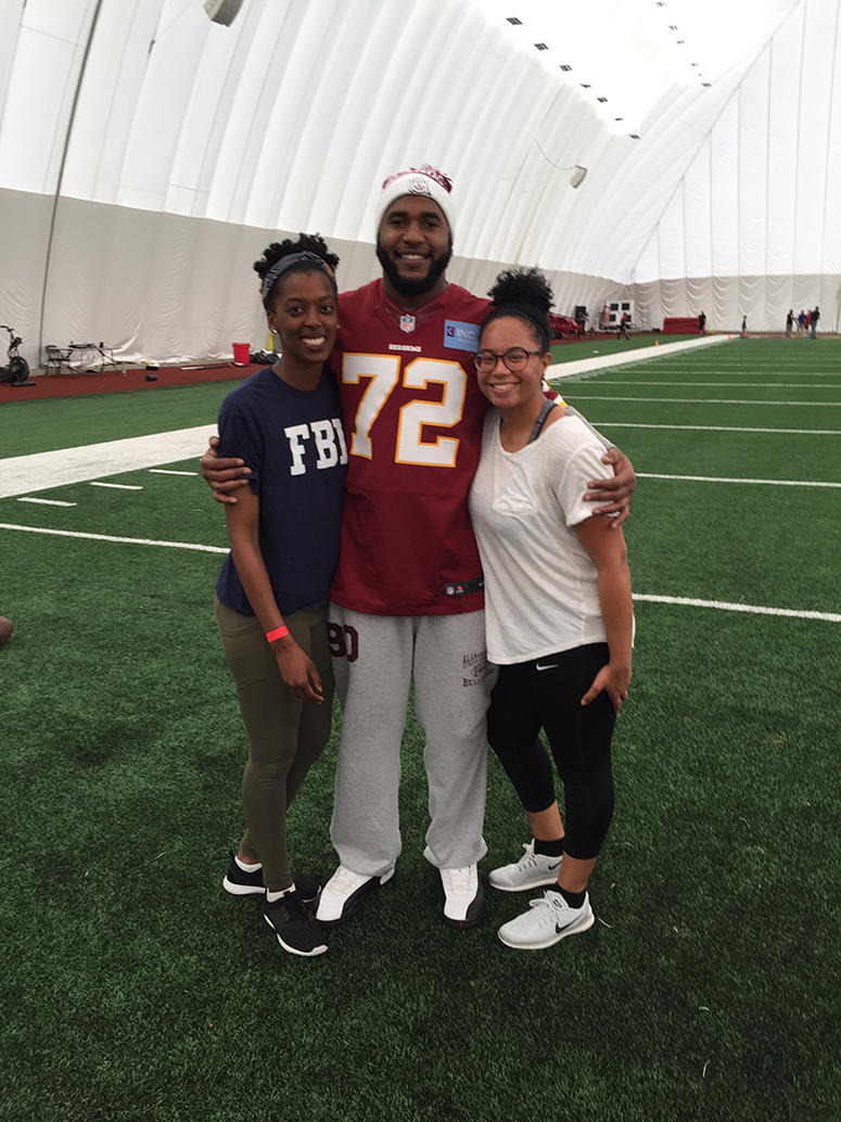 Kaylah pictured with a relative (far left) and Redskins defensive lineman Anthony Lanier II (middle).