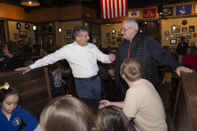 Mission BBQ Co-Founder Bill Kraus (white shirt) speaks to a customer at a Kenosha, WI Fire Night event