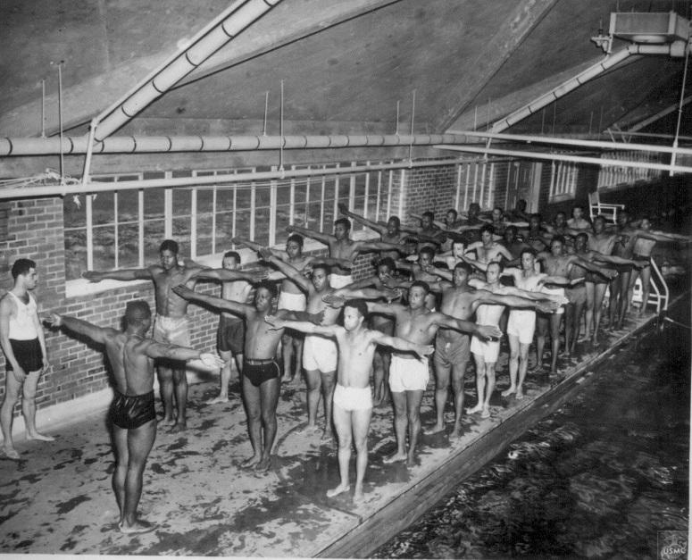 Under the direction of Swimming Instructor, Marine Pfc. Paul Tolliver..., Leathernecks in training at Montford Point Camp learn the correct movements for the breaststroke.